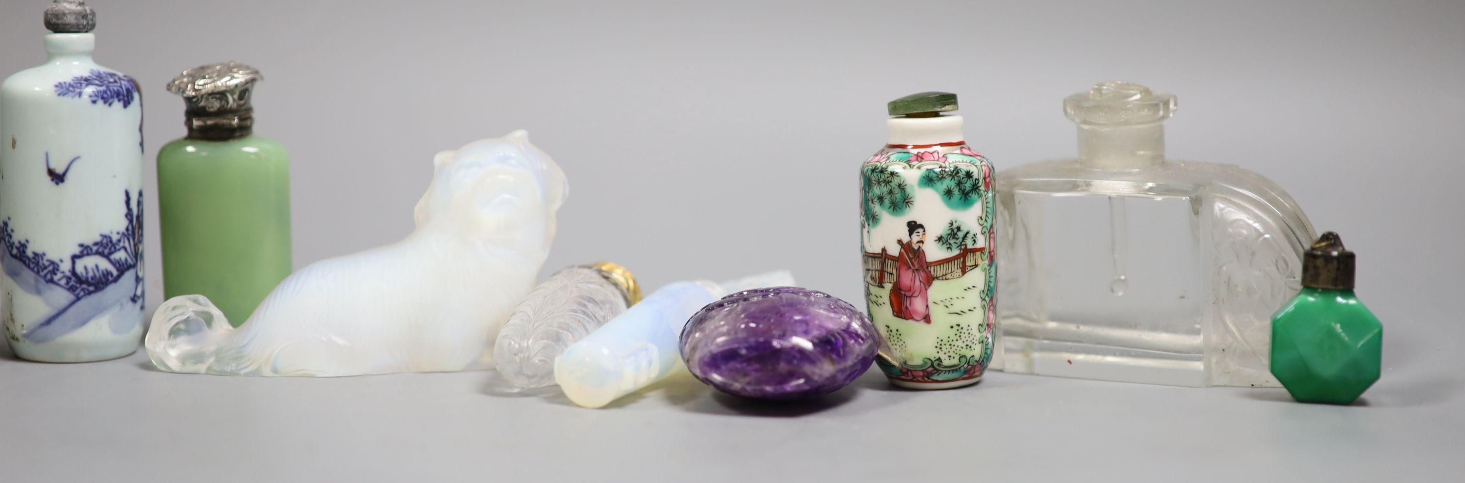 A collection of Chinese snuff bottles and European glass scent bottles, an opalescent glass figure of a dog etc.